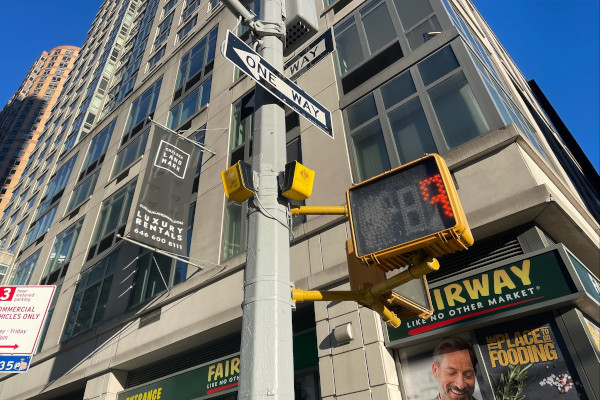 The accessible pedestrian signal aBeacon fixed on a pole at the beginning of a crossing in New York City